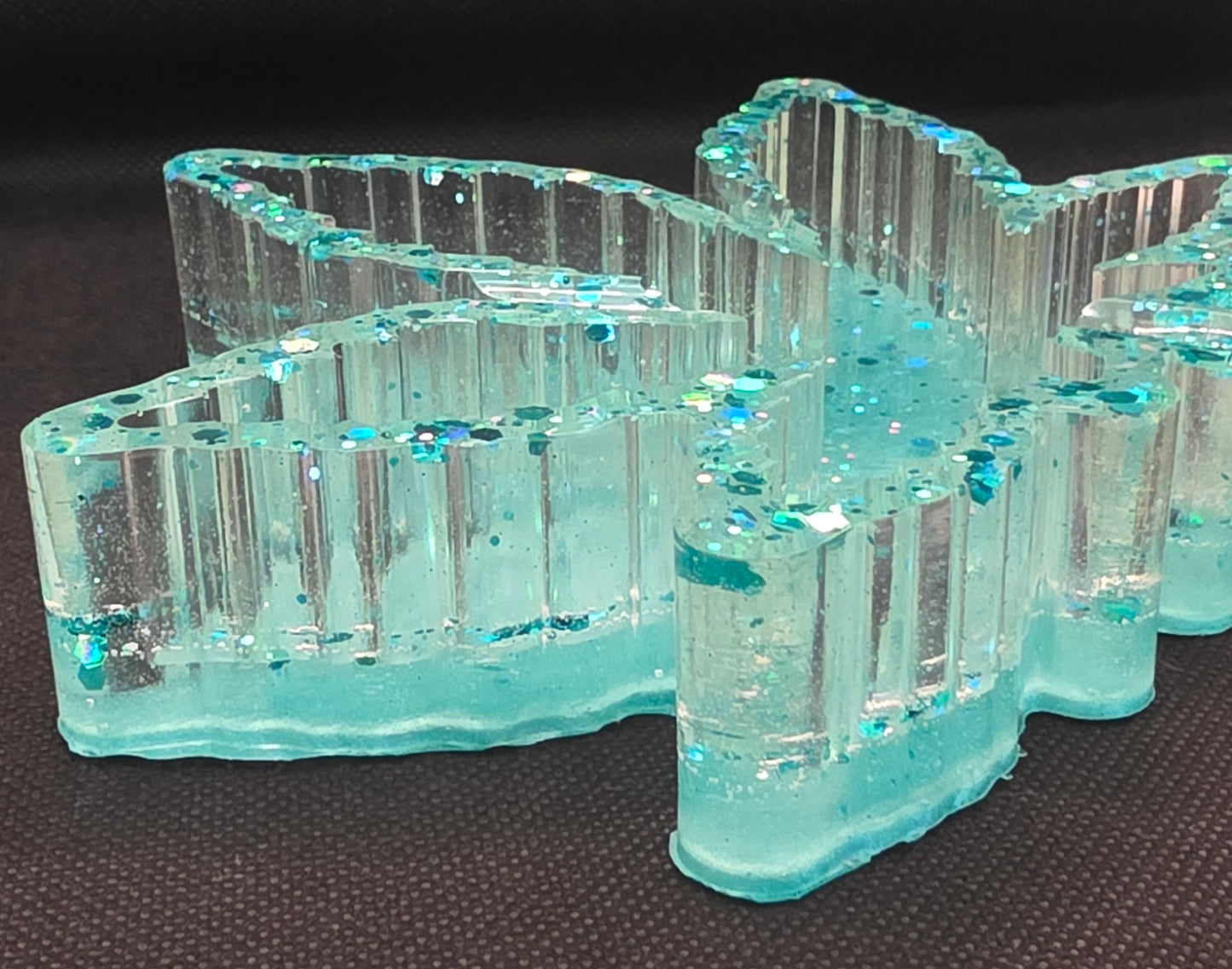 Clear with teal glitter and a teal bottom